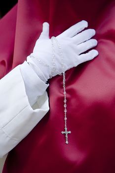 Penitent with a rosary in his hand in a procession, Spain