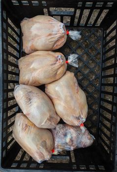 Poultry abattoir with crate of packed chicken carcasses for the local food markets.