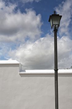 A wrought iron lamp on a weathered wall in Spain