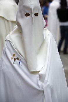 penitent white tunic in a Holy week procession, Spain