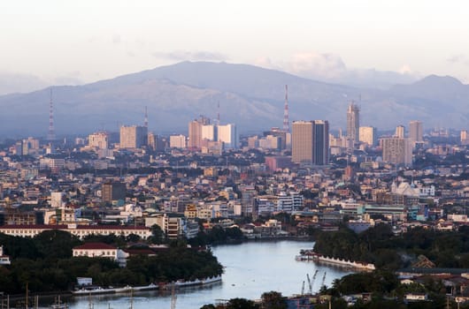 river view in the middle of the city and the mountains in the background