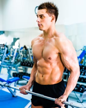 bodybuilder with barbell in gym