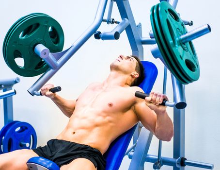 bodybuilder doing exercises on the simulator