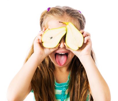 little girl with two halves of pears shows tongue on a white background