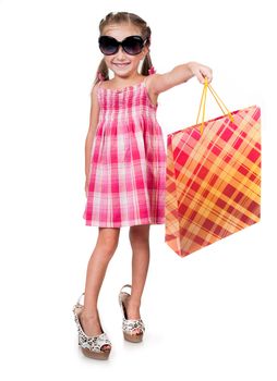 cute little girl with shopping bag in sunglasses isolated on white background