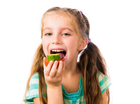 little girl with cucumber and tomato slices isolated on white background