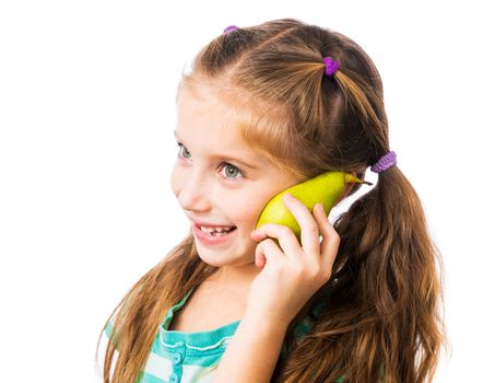 little girl with half pear as mobile phone on a white background