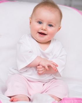 Cute baby sitting on the bed