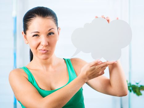 Gloomy young brunette woman holding a white cloud for text