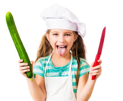 little girl in chef hat with cucumber and knife