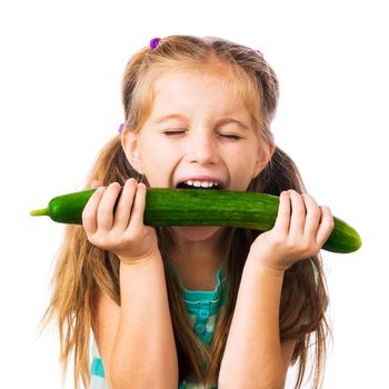 little girl biting cucumber isolated on white background