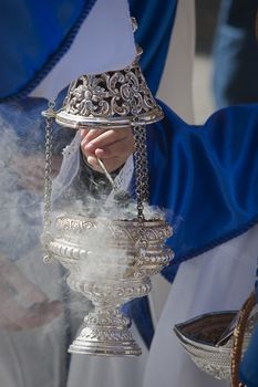 Young people in procession with incense burners in Holy week, Spain