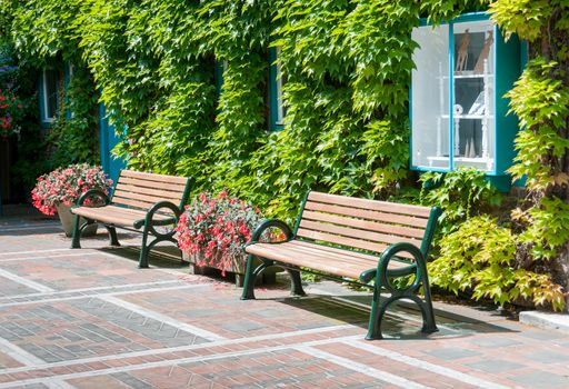 patio with place to sit and relax between the flowers and green