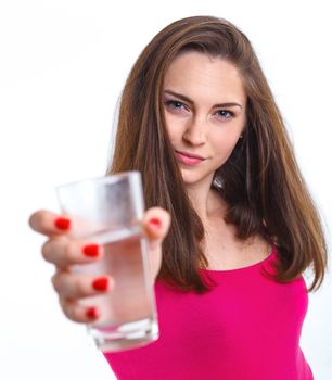 Portrait of attractive caucasian teenager girl drinking water at the glass. Isolated on white background.