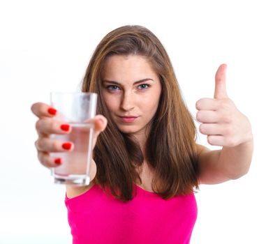 Portrait of attractive caucasian teenager girl drinking water at the glass. Isolated on white background.