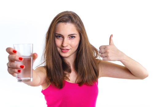 Portrait of attractive caucasian teenager girl drinking water at the glass. Isolated on white background.