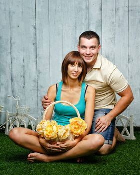 Young, happy married couple relaxing on the lawn and enjoys