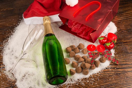 Bottle of champagne surrounded by a  Christmas still life