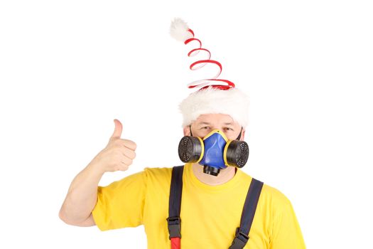 Worker in gas mask and fun hat shows thumb. Isolated on a white backgropund.