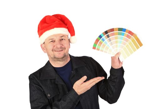 Man in santa's hat with color samples. Isolated on a white background.