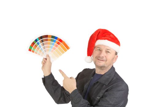 Man in santa's hat with color samples. Isolated on a white background.