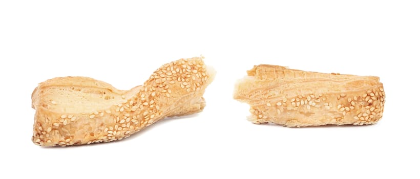 Broken cheese stick with seeds. Isolated on a white background