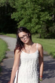 Young beautiful girl in park. Whole background.