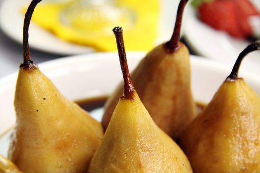 Delicious poached pear with chocolate syrup and cream.