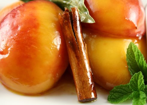 Background of poached nectarines with honey syrup nut yogurt and a cinnamon stick.
