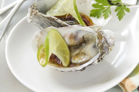 Delicious lime and soy sauce oysters in their shells ready to serve.