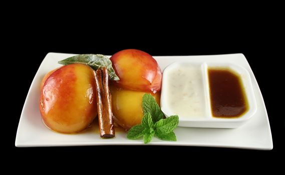 Poached nectarines with honey syrup nut yogurt and a cinnamon stick.
