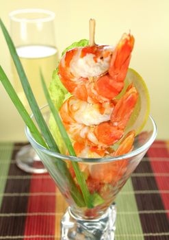 Delicious fresh shrimp cocktail with an avocado salad with spring onions.