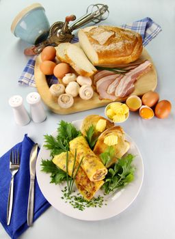 Delicious rolled mushroom and bacon omelette freshly prepared and ready to serve.