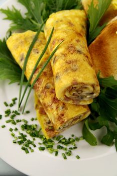 Delicious rolled mushroom and bacon omelette freshly prepared and ready to serve.