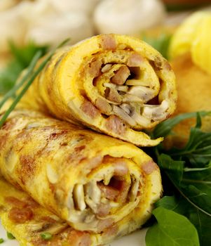 Delicious rolled mushroom and bacon omelette freshly prepared and ready to serve.