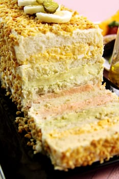 Layered salmon, avocado and curried egg loaf ready to serve.