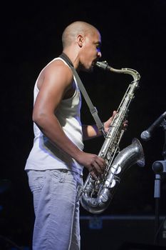 Young playing the saxophone in a blues festival, Spain
