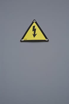 Signal of danger of electrocution from high voltage isolated in grey