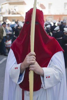 Detail penitent  holding a palm during Holy Week on Palm sunday, Spain