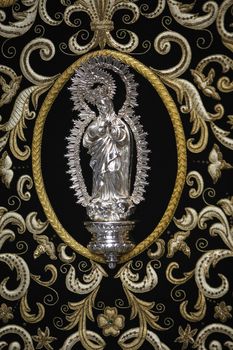 Detail the Virgin's mantle embroidered on red velvet, Seville, Andalusia, Spain