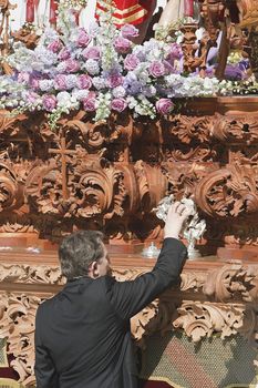 Capataz tapping with the caller of silver to get the throne during a procession of Easter, Andalusia, Spain