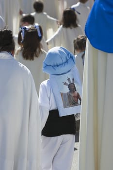 Boy dressed in costalero during a procession of holy week, Andalucia, Spain