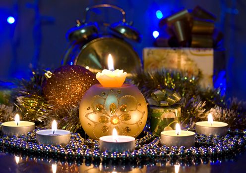 Christmas arrangement of burning candles and gifts