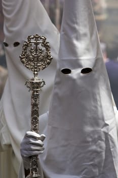 Penitent with staff of silver during a procession of holy week on Palm Sunday, Spain