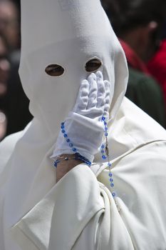 Penitent with a rosary in his hand in a procession, Andalusia, Spain