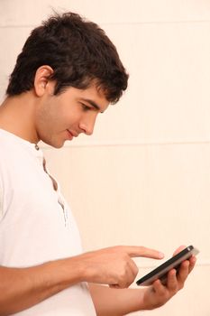 A young, latin man playing with a Tablet PC, face in focus