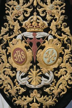 Detail of embroidery on velvet dark green, coat of arms of the brotherhood of Holy week, Andalusia, Spain