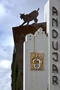 Monument to the Iberian lynx containing letters in vertical city of Andujar and the coat of arms of the city on a monolith of granite, Andujar, Jaen province, Andalusia, Spain