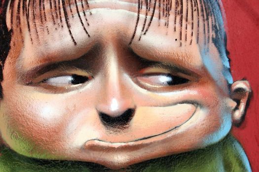 Grafitti of a child looking at the left with living colors, Andalusia, Spain