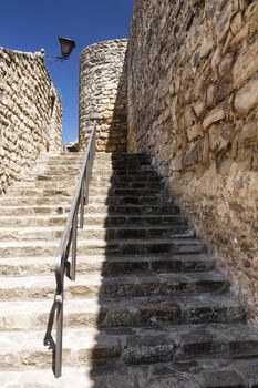 Stone stairs next to fortress from the 16th century on a sunny day, Street of Sabiote, Jaen province, Andalusia, Spain